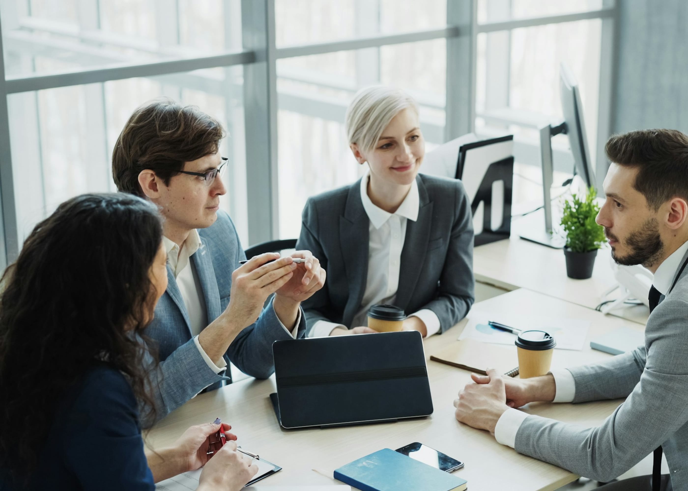 Colleagues working together around a table in an office